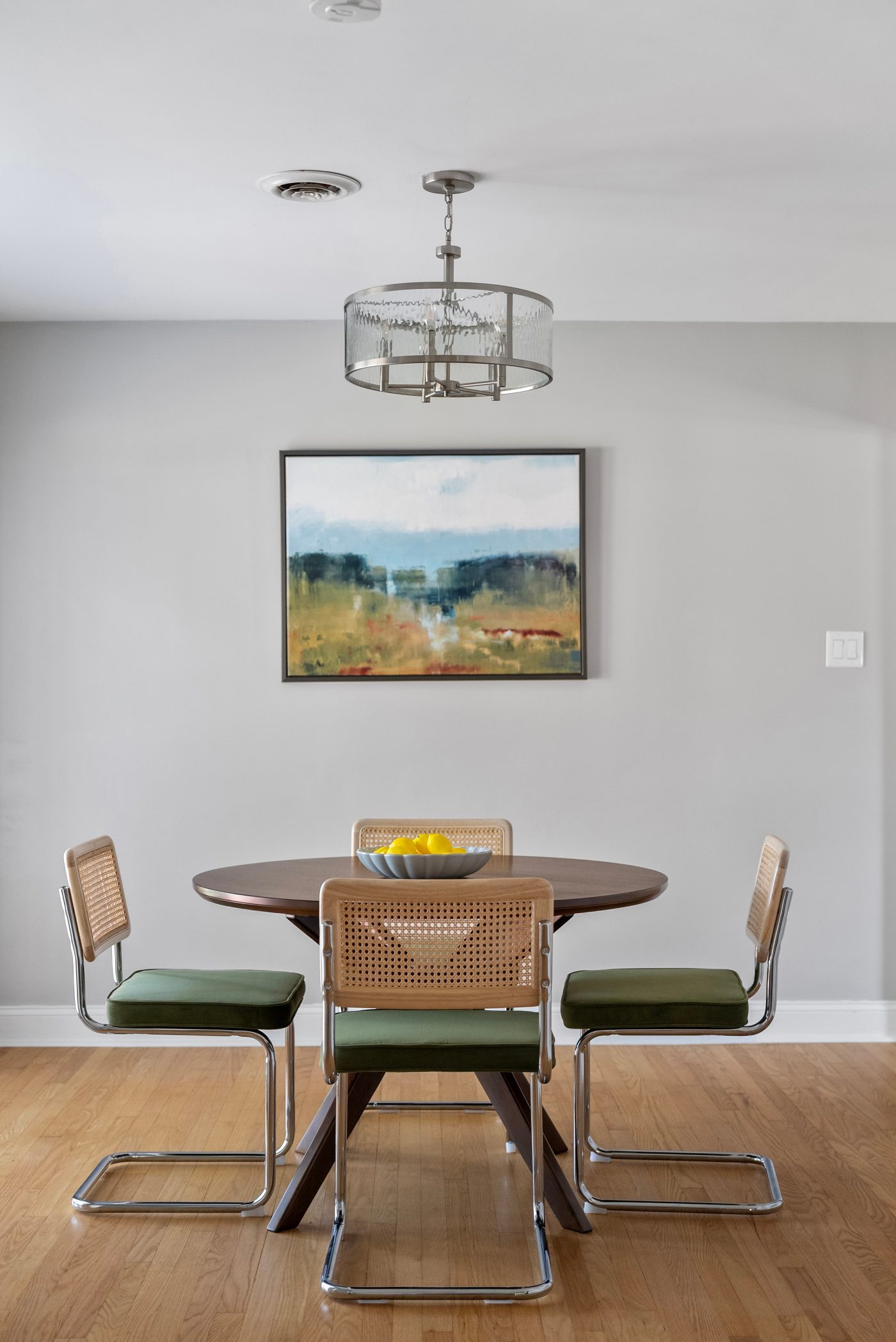 Simple dining table staging with minimal centerpiece