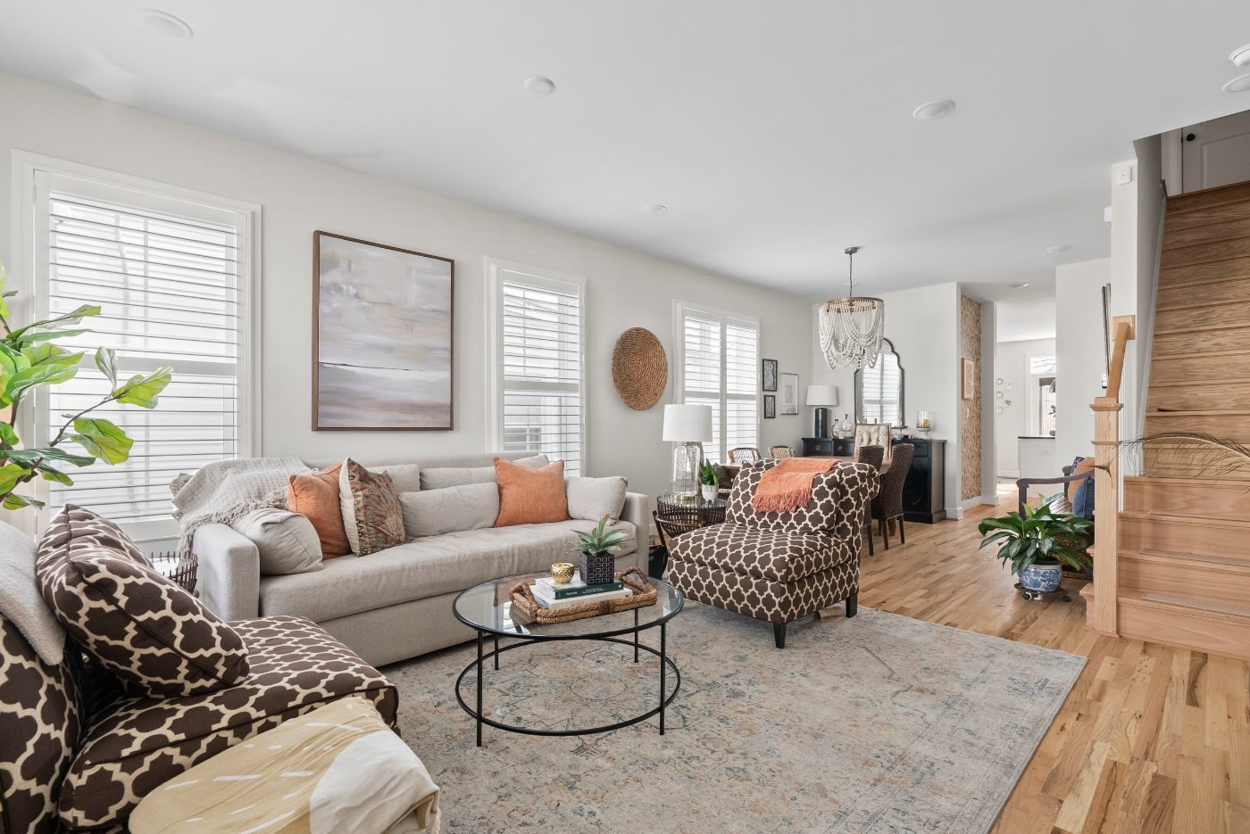 Open living and dining room with light furniture and clear surfaces