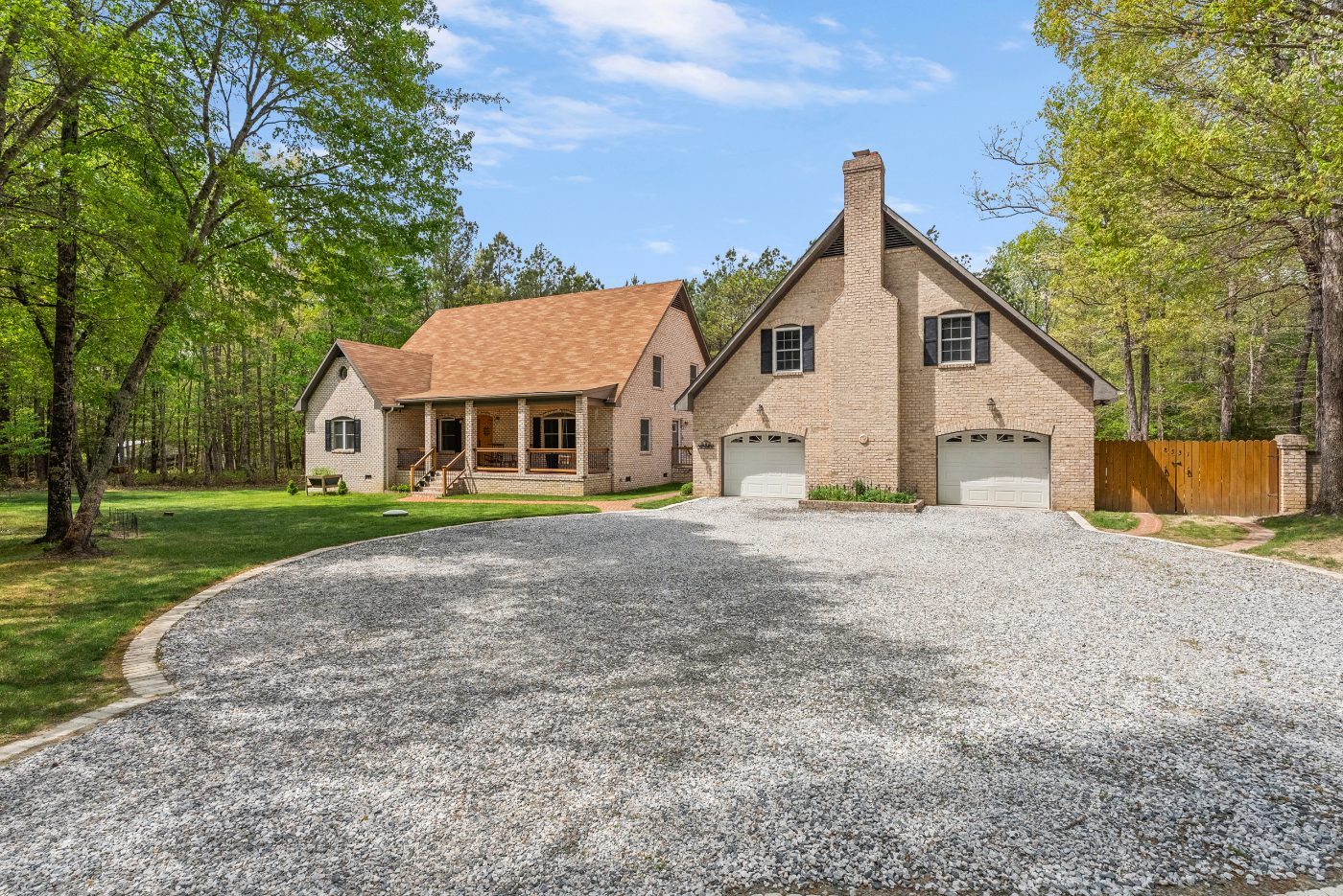 Two-story brick home with carriage house and circular driveway